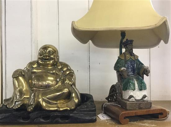 Chinese brass figure of Hotei, hardwood base & a Chinese earthenware figural table lamp